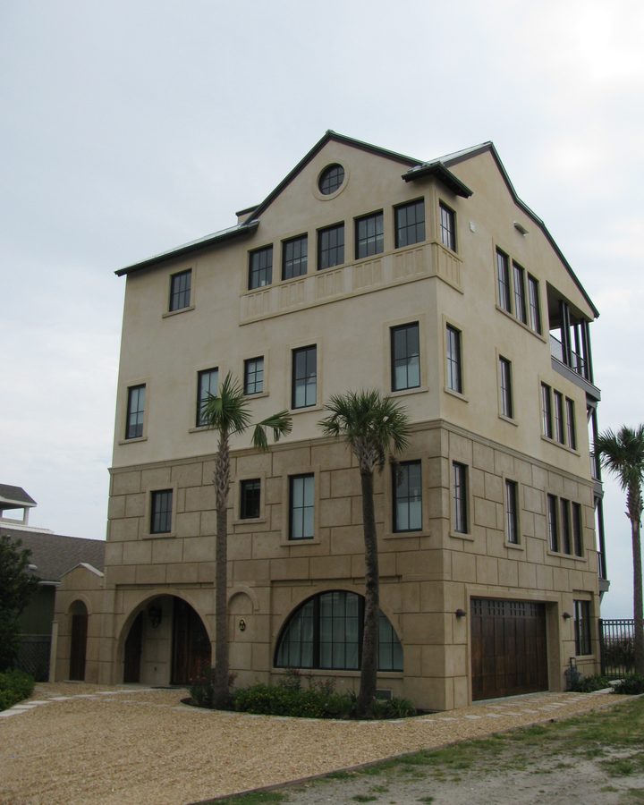 A four-storey coastal house in coated stone.