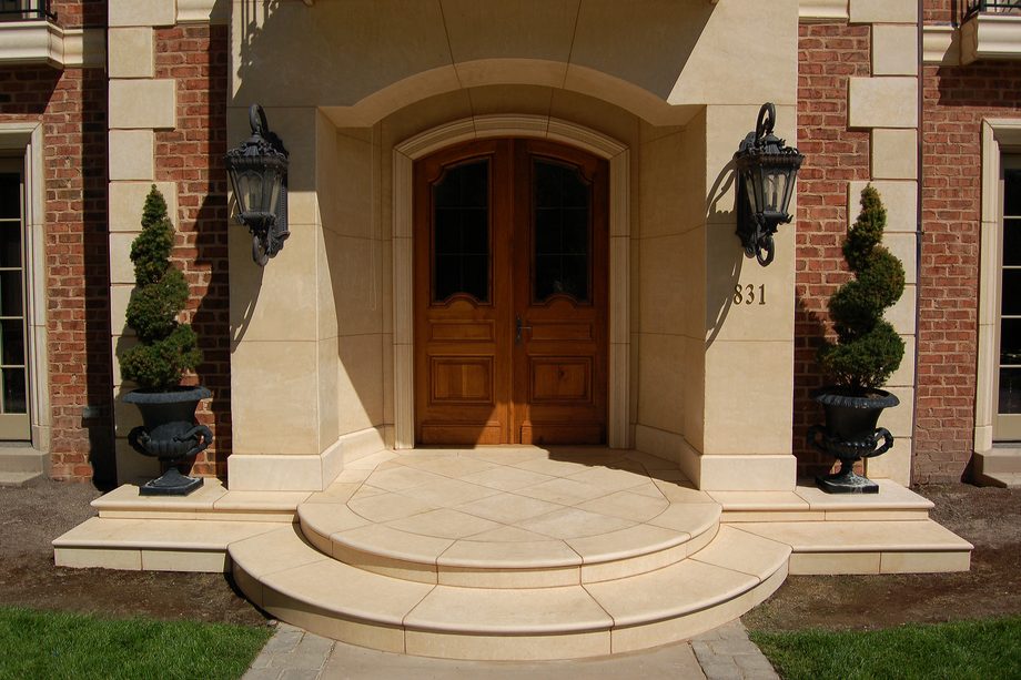A coated entrance surround with curved front steps.