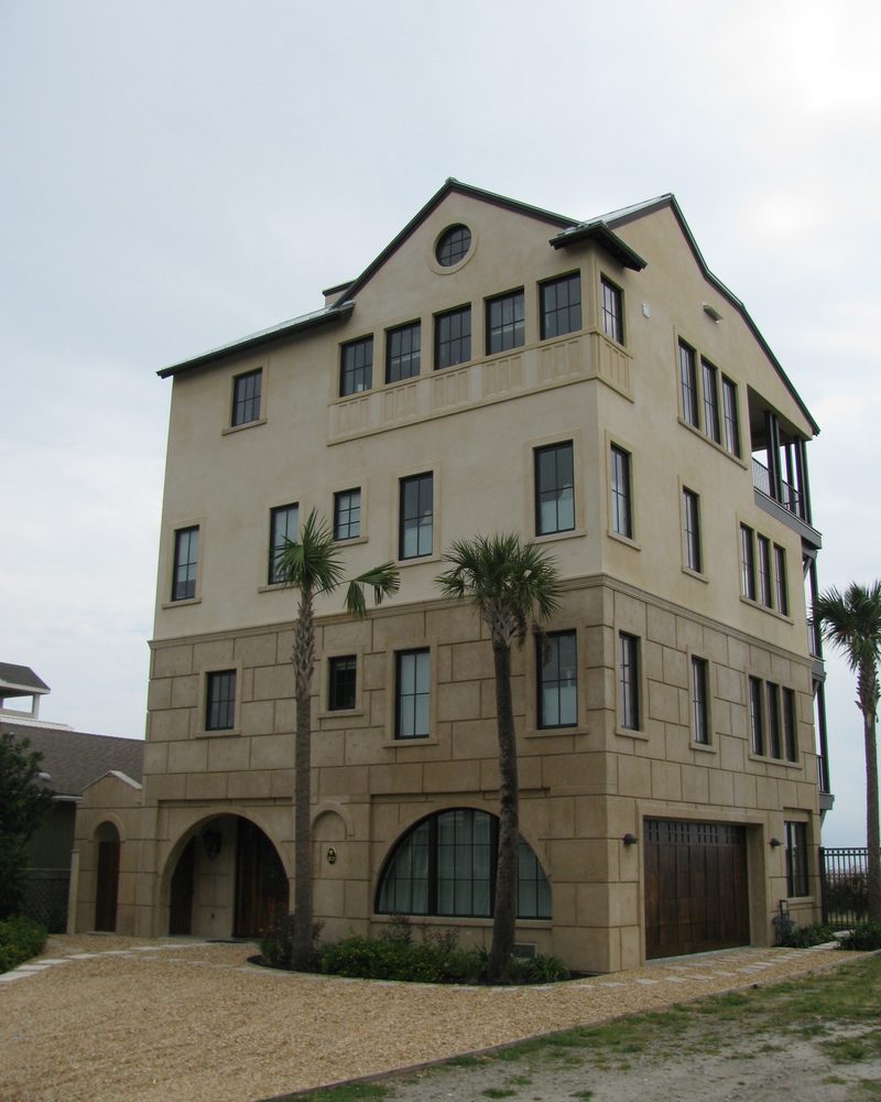 A four-storey coastal house in coated stone.