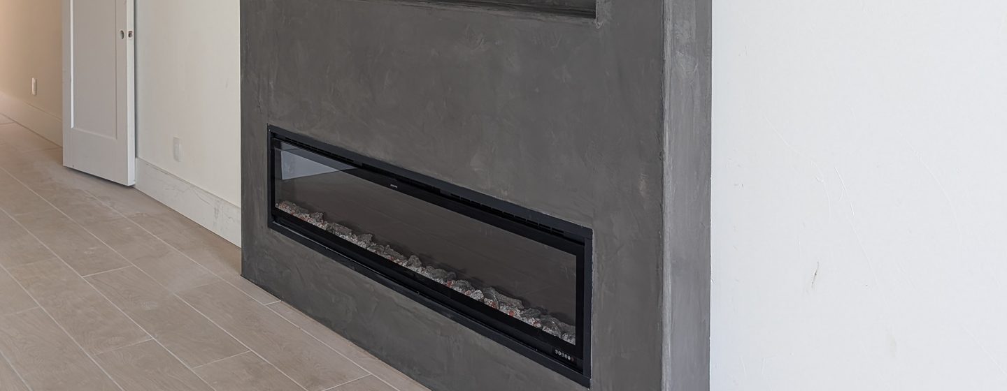 A charcoal coated fireplace wall seen at an angle.
