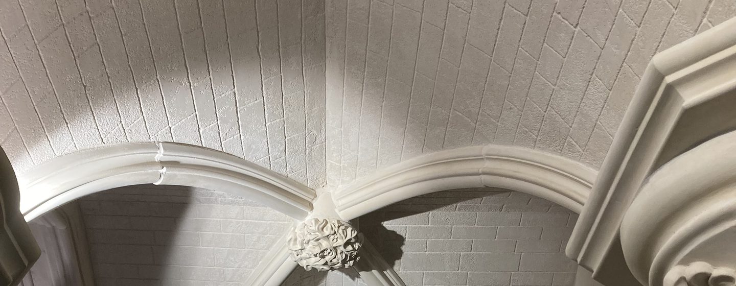 A vaulted ceiling of cut-stone blocks in Stonecoat.