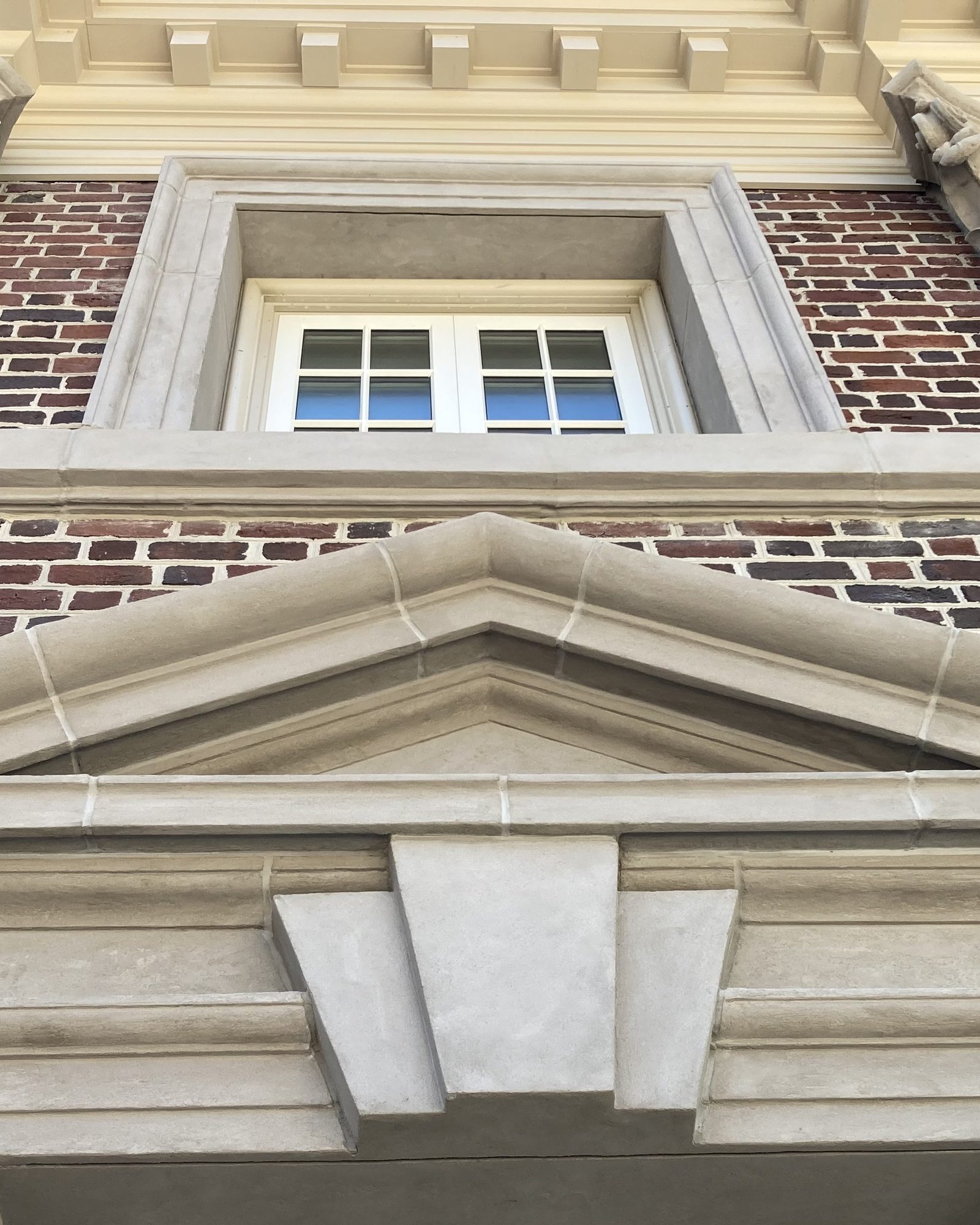 A pediment and keystone over a window in Arcus Plaster.