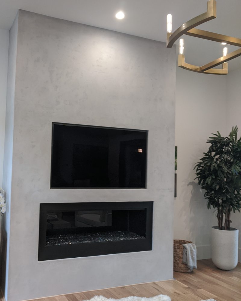 A modern fireplace wall in smooth grey Marblecoat.