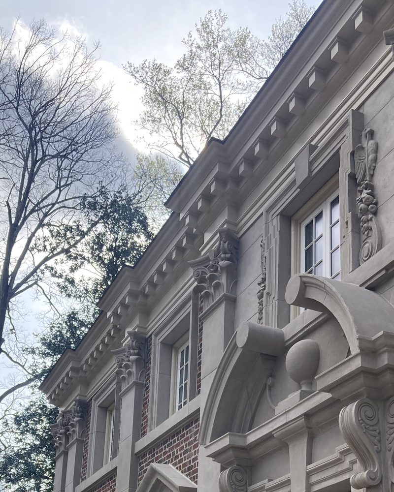 A classical facade with carved door surrounds in Arcus Plaster.