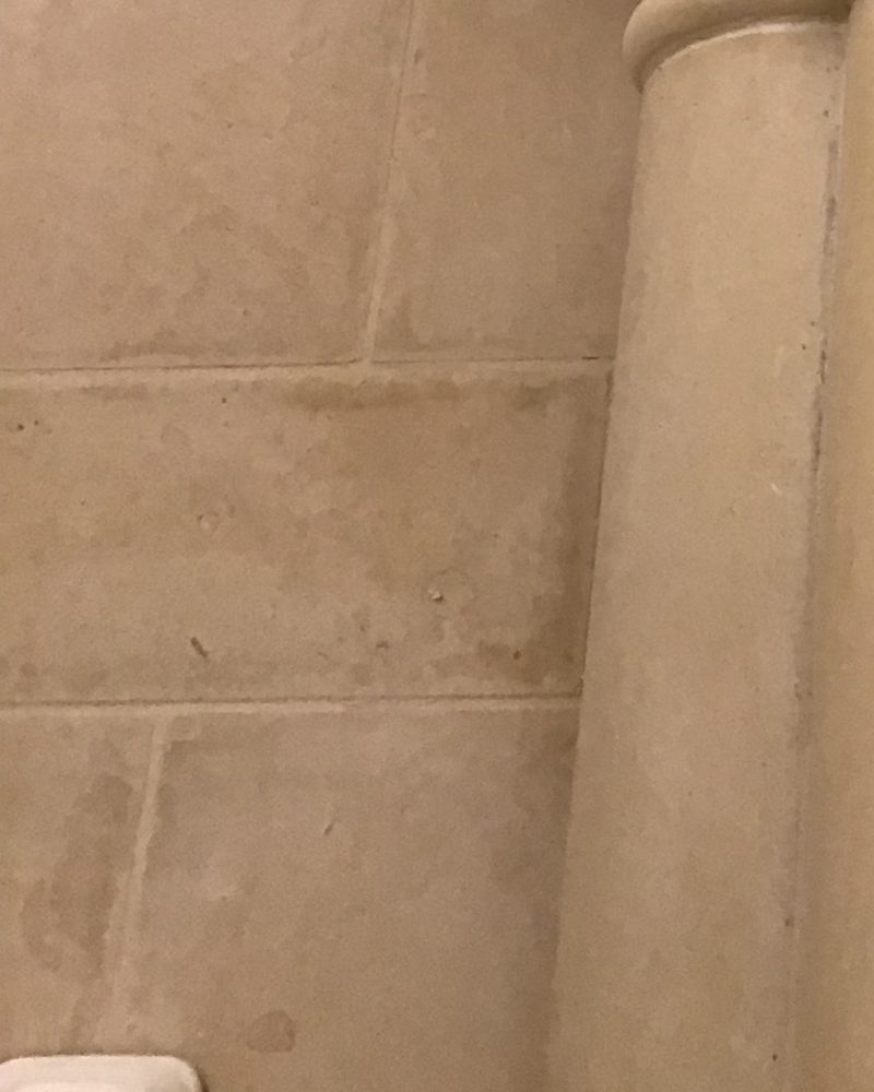 A carved column capital and cut-block walls in Stonecoat.