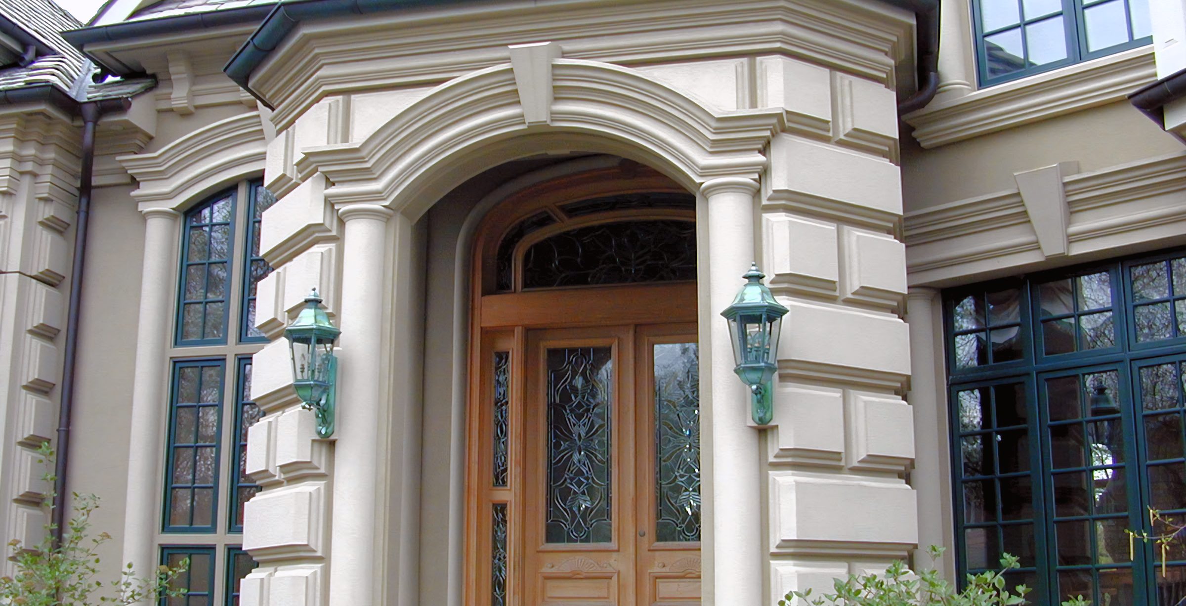 A grand portico entrance in cream coated stone.