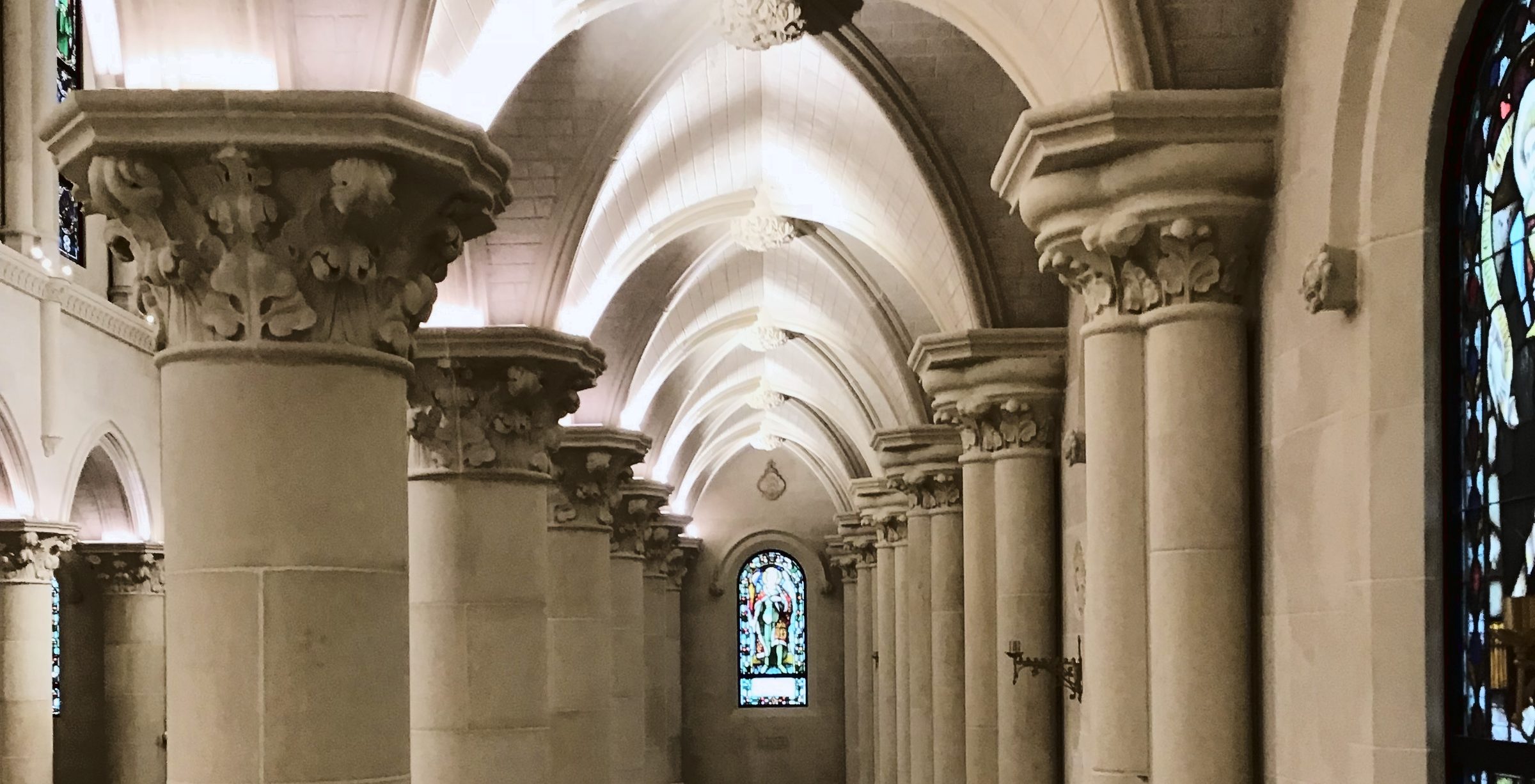 A long colonnade under a vaulted ceiling, finished in Stonecoat.